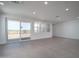 Bright, expansive living room with a sliding glass door and tile flooring at 7956 W Griswold Rd, Peoria, AZ 85345