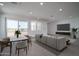 Living room and dining area with modern furnishings, neutral tones, and an abundance of natural light at 7956 W Griswold Rd, Peoria, AZ 85345
