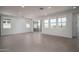 Spacious living room with tiled floors, recessed lighting, and multiple windows at 7956 W Griswold Rd, Peoria, AZ 85345