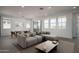 Bright living room with a large sectional couch, dining table and chairs and lots of natural light at 7956 W Griswold Rd, Peoria, AZ 85345