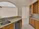 Wet bar area with granite counters, custom cabinetry, and tile floor at 8031 W Morten Ave, Glendale, AZ 85303