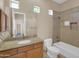 Bathroom vanity with granite countertops, tile floors, and shower-tub combo at 8031 W Morten Ave, Glendale, AZ 85303