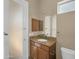 Bathroom features a sink with granite countertops and wooden cabinets at 8031 W Morten Ave, Glendale, AZ 85303