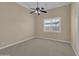 Spacious bedroom features carpet flooring, a ceiling fan, and a window for natural light at 8031 W Morten Ave, Glendale, AZ 85303