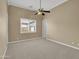 Spacious bedroom with carpet flooring, ceiling fan, and window views at 8031 W Morten Ave, Glendale, AZ 85303