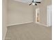 Neutral bedroom with carpet, tan walls, ceiling fan, and an open door to a dressing area at 8031 W Morten Ave, Glendale, AZ 85303