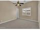 Bedroom with carpet flooring, ceiling fan, and white trim at 8031 W Morten Ave, Glendale, AZ 85303