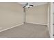 Spacious bedroom featuring neutral carpet, tan walls, ceiling fan, and ample natural light at 8031 W Morten Ave, Glendale, AZ 85303