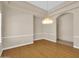 Elegant dining area features hardwood floors, decorative chandeliers, and plenty of natural light at 8031 W Morten Ave, Glendale, AZ 85303