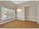 Classic dining room features hardwood floors, plantation shutters, and a decorative chandelier at 8031 W Morten Ave, Glendale, AZ 85303