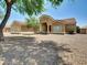 Inviting single-story home featuring desert landscaping, a tile roof, and a welcoming front entrance at 8031 W Morten Ave, Glendale, AZ 85303