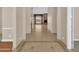 Bright foyer featuring neutral walls and decorative tile leading into an open living space with a brick fireplace at 8031 W Morten Ave, Glendale, AZ 85303