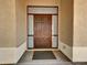 Elegant wood front door with decorative sidelights and transom, offering privacy and natural light at 8031 W Morten Ave, Glendale, AZ 85303