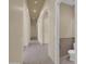 Hallway with tile flooring and archway, leading to a half bathroom at 8031 W Morten Ave, Glendale, AZ 85303