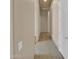 Long hallway with neutral colors and tile flooring at 8031 W Morten Ave, Glendale, AZ 85303