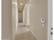 Hallway featuring arched doorways and neutral tile flooring at 8031 W Morten Ave, Glendale, AZ 85303