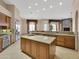 A gourmet kitchen boasts granite countertops, stainless steel appliances, and a large central island at 8031 W Morten Ave, Glendale, AZ 85303