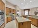 Kitchen with central island, stainless steel appliances and view of the backyard at 8031 W Morten Ave, Glendale, AZ 85303