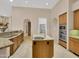 A kitchen featuring an island, granite counters, tile backsplash, stainless appliances and wood cabinets at 8031 W Morten Ave, Glendale, AZ 85303
