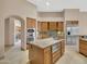Kitchen with stainless steel appliances, wood cabinets, an island, and tile floors at 8031 W Morten Ave, Glendale, AZ 85303