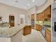 Gourmet kitchen with granite counters, tile backsplash, wood cabinets and stainless steel appliances at 8031 W Morten Ave, Glendale, AZ 85303