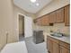 Well-lit laundry room with modern washer, dryer and plenty of storage at 8031 W Morten Ave, Glendale, AZ 85303