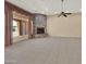 Bright living room features a stone fireplace, tile flooring, and natural light streaming through large windows at 8031 W Morten Ave, Glendale, AZ 85303