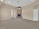 Comfortable living room with stone fireplace and neutral carpet at 8031 W Morten Ave, Glendale, AZ 85303