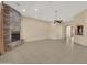Expansive living room features a stunning stone fireplace, tile flooring, and seamless transitions to other living spaces at 8031 W Morten Ave, Glendale, AZ 85303
