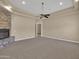 Cozy living room with a stone fireplace and plush carpeting at 8031 W Morten Ave, Glendale, AZ 85303