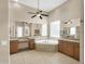 A stunning Primary bathroom boasts a large soaking tub, granite countertops, and a spacious vanity area at 8031 W Morten Ave, Glendale, AZ 85303