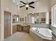 A beautiful Primary bathroom boasts a large soaking tub, granite countertops, and a spacious vanity area at 8031 W Morten Ave, Glendale, AZ 85303