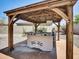 Charming outdoor kitchen in a covered gazebo, complete with a built-in grill and counter space at 8031 W Morten Ave, Glendale, AZ 85303