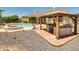 Backyard pool with covered outdoor kitchen and spa, perfect for entertaining guests at 8031 W Morten Ave, Glendale, AZ 85303