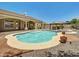 Inviting in-ground pool with spa and shaded outdoor kitchen at 8031 W Morten Ave, Glendale, AZ 85303