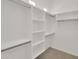Bright walk-in closet with custom built-in shelves and rod system at 8031 W Morten Ave, Glendale, AZ 85303