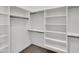 Spacious walk-in closet offering ample storage with white shelving and hanging rods at 8031 W Morten Ave, Glendale, AZ 85303