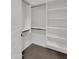 Well-organized walk-in closet features white shelving, hanging rods, and soft carpeting at 8031 W Morten Ave, Glendale, AZ 85303