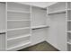 Bright walk-in closet providing organized storage solutions with built-in shelving and hanging rods at 8031 W Morten Ave, Glendale, AZ 85303