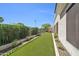 Wide view of the backyard with artificial turf, desert landscaping, and a secure green metal fence at 8180 E Shea Blvd # 1019, Scottsdale, AZ 85260