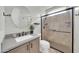 Modern bathroom with glass shower, round mirror, and stylish vanity at 8180 E Shea Blvd # 1019, Scottsdale, AZ 85260