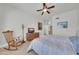 Relaxing bedroom with a rocking chair, TV on dresser, and comfortable bedding at 8180 E Shea Blvd # 1019, Scottsdale, AZ 85260