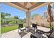 Covered patio featuring outdoor seating, a ceiling fan, and artificial turf with desert landscaping at 8180 E Shea Blvd # 1019, Scottsdale, AZ 85260