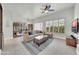 Comfortable living area with plantation shutters, tile floors, stylish furniture, and a ceiling fan at 8180 E Shea Blvd # 1019, Scottsdale, AZ 85260