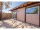 Backyard featuring a sliding door, siding, privacy wall, and concrete pavers at 909 S Acapulco Ln # A, Tempe, AZ 85281