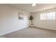 An empty, bright bedroom with carpet flooring, white walls, and a window at 909 S Acapulco Ln # A, Tempe, AZ 85281