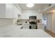 Well-lit kitchen with white cabinets, marble countertops and stainless steel appliances at 909 S Acapulco Ln # A, Tempe, AZ 85281