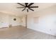 A spacious living area with a ceiling fan, open layout and easy transition to the kitchen at 909 S Acapulco Ln # A, Tempe, AZ 85281