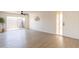 Spacious living room featuring new floors, ceiling fan, large sliding door, and ample natural light at 909 S Acapulco Ln # A, Tempe, AZ 85281