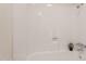 An alcove style tub with a white fiberglass surround with a shower with chrome hardware at 909 S Acapulco Ln # A, Tempe, AZ 85281